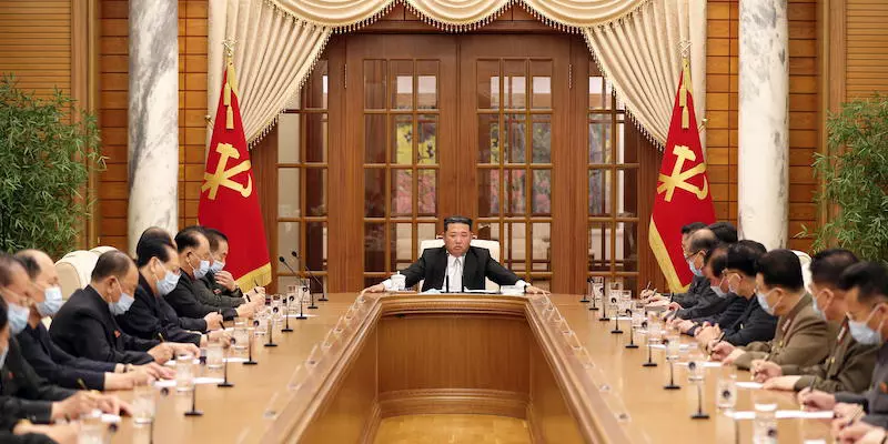 Kim Jong-un seduto a un tavolo con i suoi consiglieri